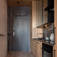 Small and wooden kitchen in corridor