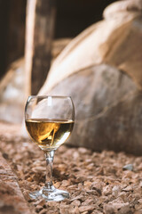 a glass of white wine in a wine cellar
