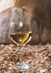 a glass of white wine in a wine cellar