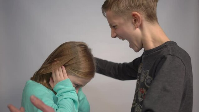 4k Emotional portrait of brother and sister teen boy shouting at little girl 