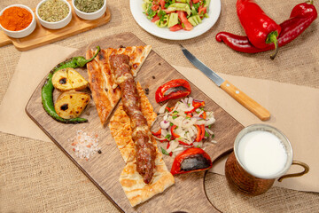 Turkish and Arabian Traditional Adana and Urfa kebab, minced meat kebab. Turkish food culture with salad on rustic wood textured background. Copy Space. stock photo
Kebab, Adana, Wrap Sandwich, Turkis