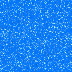 Obraz premium White speckled paper on a blue surface.