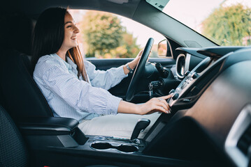 attractive young woman in casual clothes while driving a car