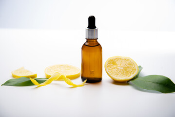 bottle with lemon essential oil, fresh lemon