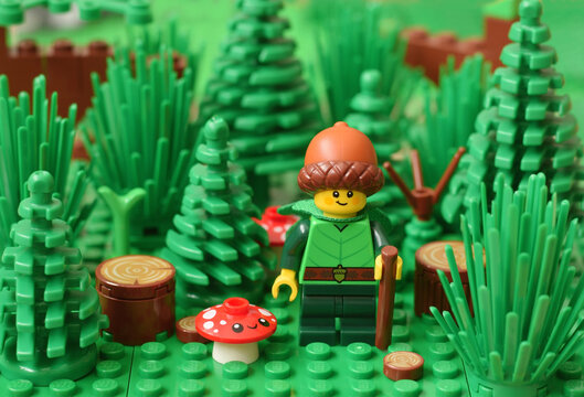 Lego minifigure series 22 with acorn hat in green forest. Editorial illustrative image of nature. Studio shot.