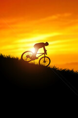 Mountain biker silhouette going downhill. Mountain bike concept and adventure.
