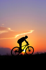 silhouette of a cyclist on sunset