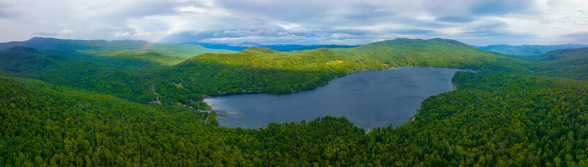 Aerial view of Rainbow over Stinson Lake in White Mountain National Forest in summer in town of Rumney, Grafton County, New Hampshire NH, USA.  - obrazy, fototapety, plakaty