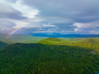 Rainbow over White Mountain National Forest aerial view near Stinson Lake in summer in town of Rumney, Grafton County, New Hampshire NH, USA. 