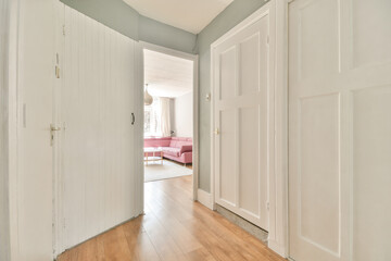 Perspective view of empty narrow hallway with white walls and wardrobe with mirror and parquet...