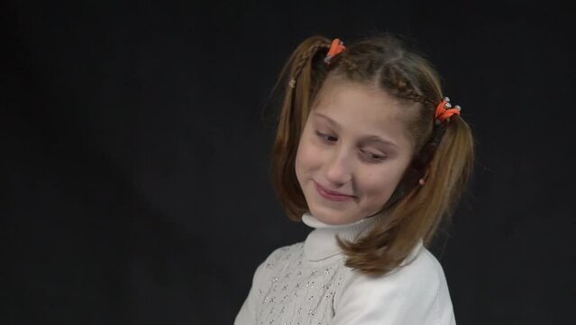 Girl looking shy and cute, blushing, looking from under forehead