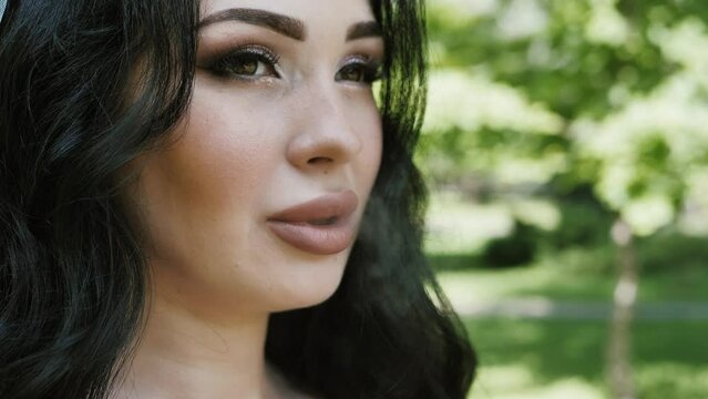 Portrait of a beautiful girl smoking an electronic cigarette and exhaling smoke. IQOS