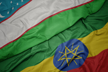 waving colorful flag of ethiopia and national flag of uzbekistan.