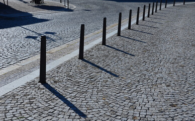 Gray metal bollards are used to protect pedestrians in the pedestrian zone or in the park on the...