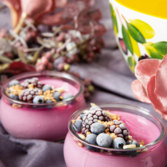 Cold refreshing fruit dessert in small jars on a gray tablecloth