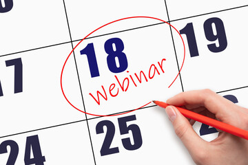 18th day of the month. Hand writing text WEBINAR and circling the calendar date.