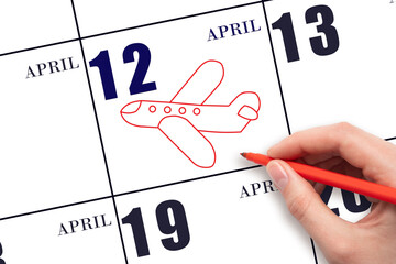 A hand drawing outline of airplane on calendar date 12 April. The date of flight on plane.