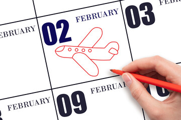 A hand drawing outline of airplane on calendar date 2 February. The date of flight on plane.