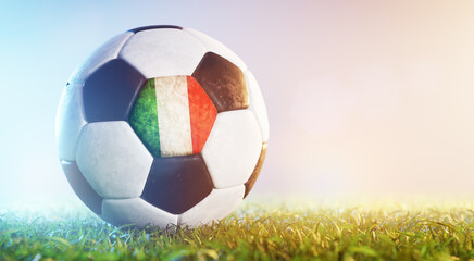 Football soccer ball with flag of Italy on grass