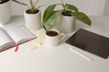 workplace background with cup of coffee and tablet