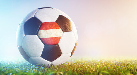 Football soccer ball with flag of Austria on grass