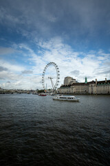 London eye with a boat in front