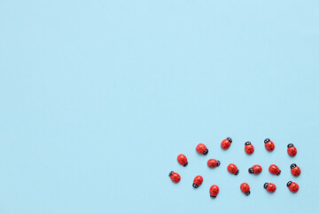 Colored wooden figures in the form of ladybugs on a blue background
