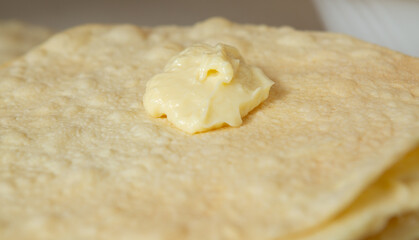 Sweet, fragrant cream is applied to the next layer of Napoleon cake