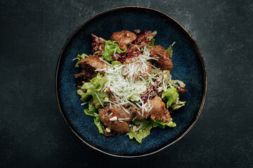 Warm salad with liver and cheese, artistic processing