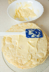 Sweet, fragrant cream is applied to the next layer of Napoleon cake
