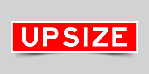 Red color square shape sticker label with word upsize on gray background