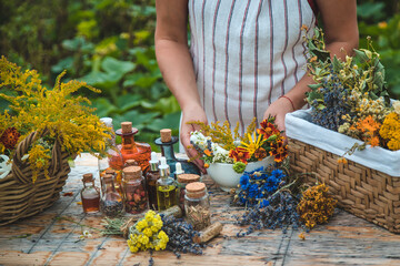 Woman with medicinal herbs and tinctures. Selective focus.