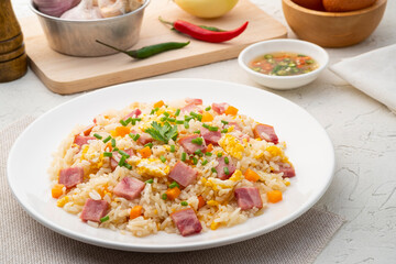 Thai Fried rice with egg and sliced ham carrot in white plate.Easy cooking food