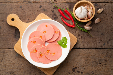Spicy Sliced Bologna sausage with Chili in white plate.Top view © Kritchai
