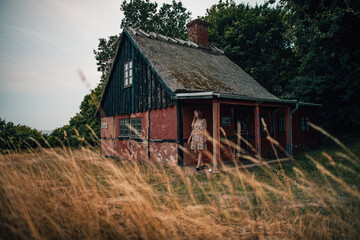 Girl at a red old house in denmark