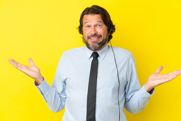 Telemarketer dutch man working with a headset isolated on yellow background with shocked facial expression