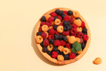 Raspberries of three colors are yellow, red and black, top view.