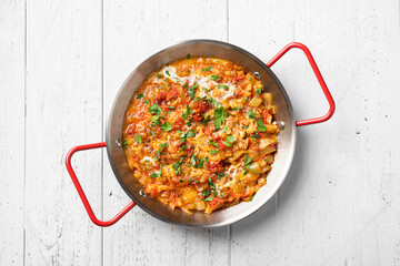 Menemen, Turkish breakfast, eggs with peppers and tomatoes, top view