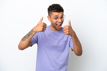 Young caucasian Brazilian man isolated on white background giving a thumbs up gesture