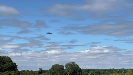 Royal Air Force Airbus A400M Atlas military plane (ZM4141) flying low level in preparation for dropping parachute regiment soldiers on an airborne assault military exercise, summer bright cloud sky