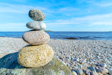 Pyramid of stones. Unstable balance of stone objects. Idyllic state of nature.