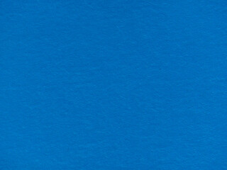 Textured background made of dark blue paper. The texture of blue paper. Blue textured background made of recycled cardboard