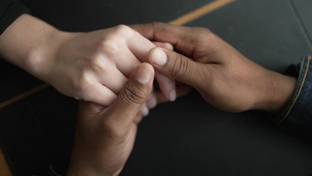 Young couple hands joining in care and support. Closeup hand togehter in union. reaching out for friend