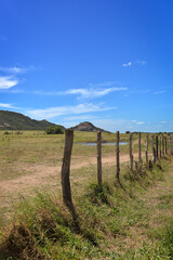 Fototapeta na wymiar landscape with lake, fence and mountain, Araruna, Pb, Paraíba, Brazil, brazilian trails, travels in brazil, northeastern brazil