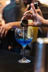 bartender pouring alcohol into glass