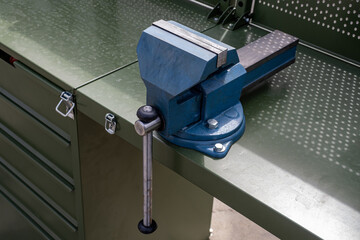 Vise grip stationary. Steel vise fixed on table. Tool for mechanical work. Mechanics desktop....