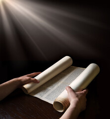 Hands holding an ancient scroll