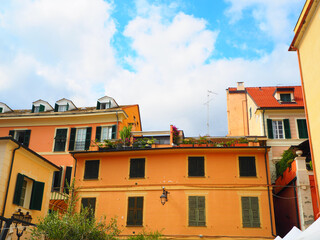 Fototapeta na wymiar Typical colorful old facades of city Laigueglia (province of Savona) on the Italian Riviera in Western Liguria, Italy