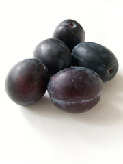 ripe juicy plums on white background	