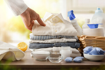 Products and person showing freshly washed clothes in a room